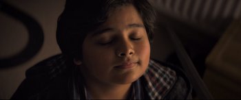 Movie still from “The Kid Who Would Be King” (2019), directed by Joe Cornish – A young boy with his eyes closed and his head tilted to the side; Close Up shot, High angle