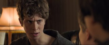 Movie still from “The Kid Who Would Be King” (2019), directed by Joe Cornish – A young man with a frown on his face; Close Up shot, Over the shoulder angle