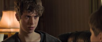 Movie still from “The Kid Who Would Be King” (2019), directed by Joe Cornish – A young man with a concerned look on his face; Close Up shot, Over the shoulder angle