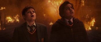 Movie still from “The Kid Who Would Be King” (2019), directed by Joe Cornish – A couple of people standing next to each other in a room; Medium shot, High angle