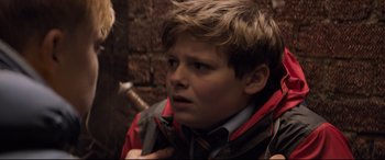 Movie still from “The Kid Who Would Be King” (2019), directed by Joe Cornish – A young boy is holding a knife in his hand; Close Up shot, Over the shoulder angle