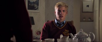 Movie still from “The Kid Who Would Be King” (2019), directed by Joe Cornish – A young man sitting at a dining room table; Close Up shot, Over the shoulder angle