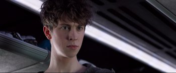 Movie still from “The Kid Who Would Be King” (2019), directed by Joe Cornish – A young person with a serious look on his face; Close Up shot, Low angle
