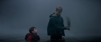 Movie still from “The Kid Who Would Be King” (2019), directed by Joe Cornish – Two young boys in a body of water; Medium shot, Over the shoulder angle