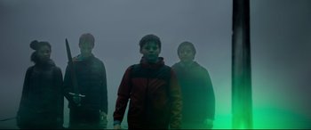 Movie still from “The Kid Who Would Be King” (2019), directed by Joe Cornish – A group of young people standing in a foggy area; Medium shot, Low angle