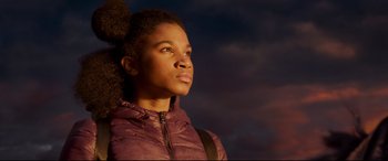 Movie still from “The Kid Who Would Be King” (2019), directed by Joe Cornish – A woman in a purple jacket looking to her left; Close Up shot, Low angle