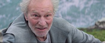 Movie still from “The Kid Who Would Be King” (2019), directed by Joe Cornish – An old man with a gray beard and a white mustache; Close Up shot, Low angle