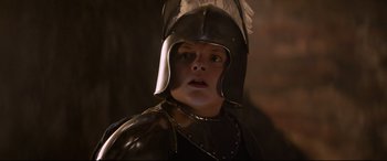 Movie still from “The Kid Who Would Be King” (2019), directed by Joe Cornish – A person wearing a helmet and a leather outfit; Close Up shot, Low angle