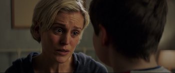 Movie still from “The Kid Who Would Be King” (2019), directed by Joe Cornish – A woman is looking at a boy in a room; Close Up shot, Over the shoulder angle