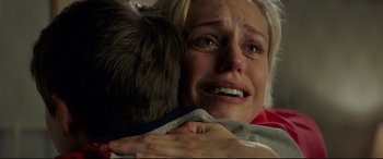 Movie still from “The Kid Who Would Be King” (2019), directed by Joe Cornish – A woman is crying while hugging a boy; Close Up shot, Over the shoulder angle