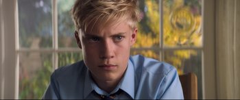 Movie still from “The Kid Who Would Be King” (2019), directed by Joe Cornish – A person wearing a shirt and tie; Close Up shot, Over the shoulder angle