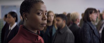 Movie still from “The Kid Who Would Be King” (2019), directed by Joe Cornish – A group of people standing in a room; Close Up shot, Over the shoulder angle