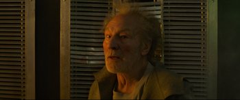 Movie still from “The Kid Who Would Be King” (2019), directed by Joe Cornish – An old man with a beard is looking at the camera; Close Up shot, Low angle