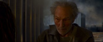 Movie still from “The Kid Who Would Be King” (2019), directed by Joe Cornish – An older man with a white beard is looking at the camera; Close Up shot, Low angle