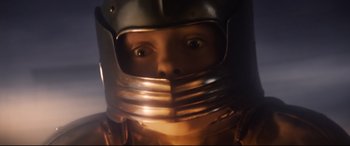 Movie still from “The Kid Who Would Be King” (2019), directed by Joe Cornish – The face of a person wearing a metal helmet; Close Up shot, Low angle