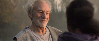Movie still from “The Kid Who Would Be King” (2019), directed by Joe Cornish – An older man with a white beard talking to a younger man; Close Up shot, Over the shoulder angle