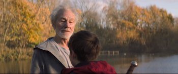 Movie still from “The Kid Who Would Be King” (2019), directed by Joe Cornish – An older man standing next to a young boy; Close Up shot, Over the shoulder angle