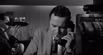 Movie still from “Days of Wine and Roses” (1962), directed by Blake Edwards – A man smoking a cigarette while talking on the phone; Close Up shot, Low angle