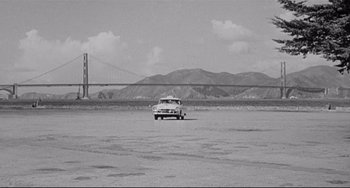 Movie still from “Days of Wine and Roses” (1962), directed by Blake Edwards – An old car is parked in the middle of the desert; Extreme Wide shot, High angle
