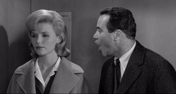 Movie still from “Days of Wine and Roses” (1962), directed by Blake Edwards – A man and a woman standing next to each other in front of an elevator; Close Up shot, Over the shoulder angle