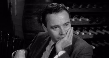 Movie still from “Days of Wine and Roses” (1962), directed by Blake Edwards – Black and white photograph of a man in a suit and tie; Close Up shot, High angle