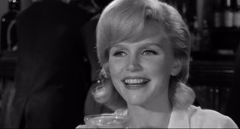 Movie still from “Days of Wine and Roses” (1962), directed by Blake Edwards – A black and white photo of a woman with a pear in her ear; Close Up shot, Over the shoulder angle
