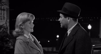 Movie still from “Days of Wine and Roses” (1962), directed by Blake Edwards – An old photo of a man and a woman talking to each other; Medium shot, High angle