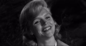 Movie still from “Days of Wine and Roses” (1962), directed by Blake Edwards – A black - and - white photo of a woman smiling for the camera; Close Up shot, Low angle