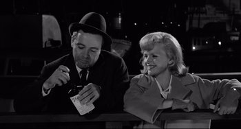 Movie still from “Days of Wine and Roses” (1962), directed by Blake Edwards – A man and a woman sitting next to each other; Medium shot, High angle