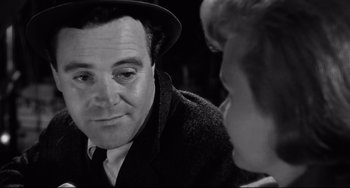 Movie still from “Days of Wine and Roses” (1962), directed by Blake Edwards – An older man wearing a hat looking at a young woman; Close Up shot, Over the shoulder angle