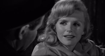 Movie still from “Days of Wine and Roses” (1962), directed by Blake Edwards – A black - and - white photo of a woman with a man in the background; Close Up shot, Over the shoulder angle