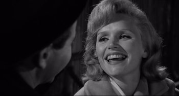 Movie still from “Days of Wine and Roses” (1962), directed by Blake Edwards – An old photo of a woman smiling at the camera; Close Up shot, Over the shoulder angle