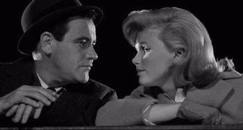 Movie still from “Days of Wine and Roses” (1962), directed by Blake Edwards – A man and a woman sitting next to each other in front of each other; Close Up shot, Low angle