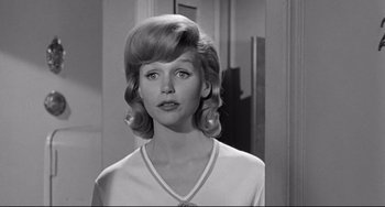 Movie still from “Days of Wine and Roses” (1962), directed by Blake Edwards – A black and white photo of a woman in a white shirt; Close Up shot, Over the shoulder angle