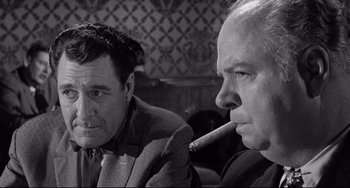 Movie still from “Days of Wine and Roses” (1962), directed by Blake Edwards – Two men sitting next to each other with a cigarette in their mouth; Close Up shot, Over the shoulder angle