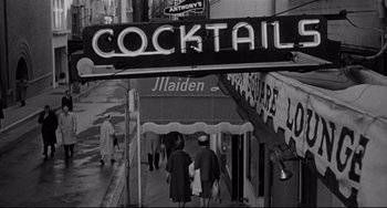 Movie still from “Days of Wine and Roses” (1962), directed by Blake Edwards – A black - and - white photo of people walking down the street; Wide shot, Low angle