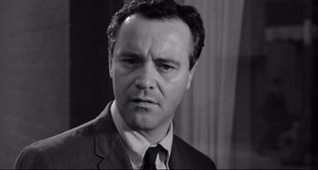 Movie still from “Days of Wine and Roses” (1962), directed by Blake Edwards – Black and white photograph of a man in a suit; Close Up shot, Low angle