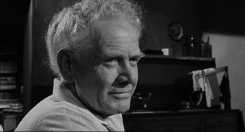 Movie still from “Days of Wine and Roses” (1962), directed by Blake Edwards – An older man is smiling for the camera; Close Up shot, Over the shoulder angle