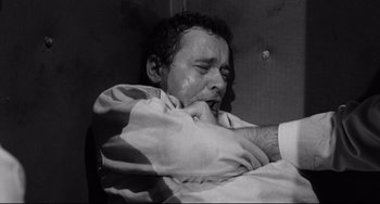 Movie still from “Days of Wine and Roses” (1962), directed by Blake Edwards – Black and white photograph of a man in a hospital bed; Close Up shot, High angle