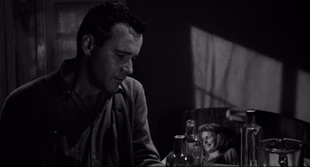 Movie still from “Days of Wine and Roses” (1962), directed by Blake Edwards – A black and white photo of a man and a woman at a table; Close Up shot, Over the shoulder angle