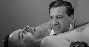 Movie still from “Days of Wine and Roses” (1962), directed by Blake Edwards – A man laying on a couch next to another man; Close Up shot, High angle
