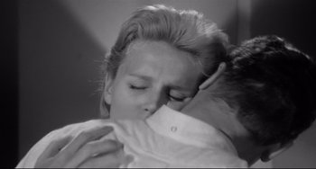 Movie still from “Days of Wine and Roses” (1962), directed by Blake Edwards – A woman is hugging a young boy in a black and white photo; Close Up shot, Low angle