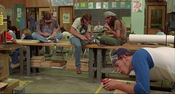 Movie still from “Dazed and Confused” (1993), directed by Richard Linklater – A group of young men sitting around a table; Wide shot, Low angle