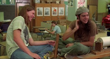 Movie still from “Dazed and Confused” (1993), directed by Richard Linklater – A group of young people sitting on the floor in front of a computer; Medium shot, Low angle