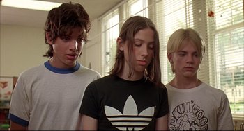 Movie still from “Dazed and Confused” (1993), directed by Richard Linklater – A group of young men standing next to each other; Close Up shot, Low angle