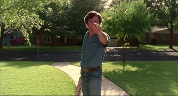 Movie still from “Dazed and Confused” (1993), directed by Richard Linklater – A young man holding a baseball bat in his hand; Medium shot, Low angle