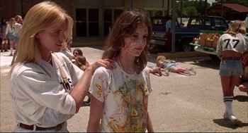 Movie still from “Dazed and Confused” (1993), directed by Richard Linklater – A girl covered in paint is being hugged by a woman; Medium shot, Low angle