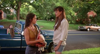 Movie still from “Dazed and Confused” (1993), directed by Richard Linklater – Two young women standing next to each other on the side of the road; Medium shot, Low angle
