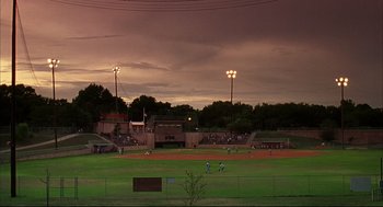 Movie still from “Dazed and Confused” (1993), directed by Richard Linklater – A group of people playing baseball on a field; Extreme Wide shot, High angle