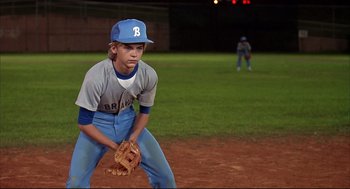 Movie still from “Dazed and Confused” (1993), directed by Richard Linklater – A young baseball player is ready to catch the ball; Medium shot, High angle